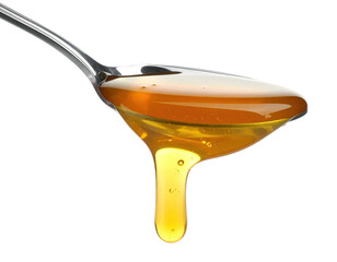 Close-up of a silver spoon holding and dripping viscous golden-colored liquid