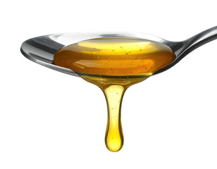 Close-up of golden, viscous liquid dripping from a metal spoon, isolated on black