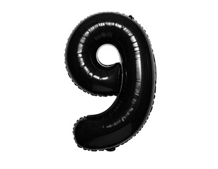 A glossy black number nine balloon against a stark black background