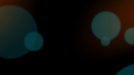 Defocussed teal bokeh circles on black background with warm orange flare effect
 - Powered by Adobe