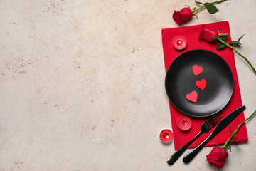 Beautiful table setting for Valentine's Day with candles and rose flowers on beige grunge background