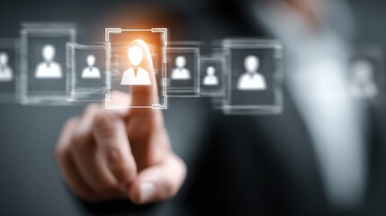 Business professional points at digital user icons on a screen during a meeting in an office setting