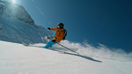 Skier riding in the scenic Dolomites mountains in fresh po . Super slow motion at 1000 fps.