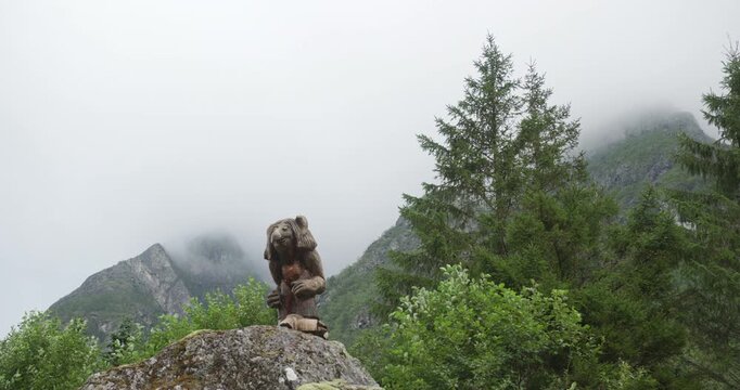 Norwegian troll sculpture standing in a misty mountain landscape