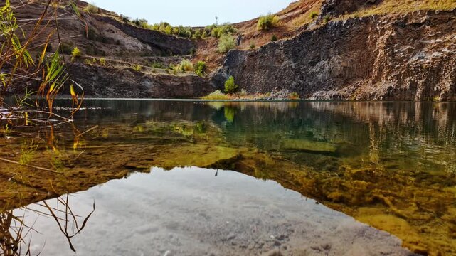 The Emerald Lake, Racos, Romania, with vivid green water, steep rock walls and a serene path along the shore