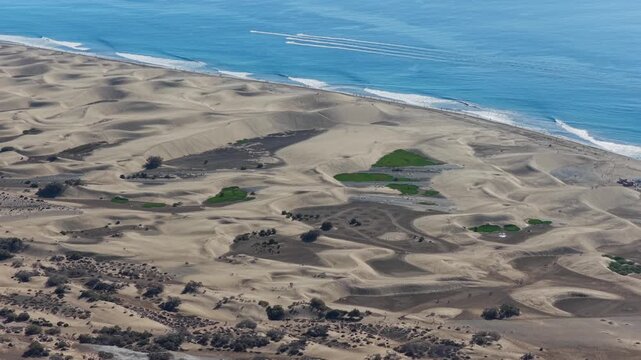 Cinematic 4K Aerial of the Maspalomas Special Natural Reserve Dunes at Sunrise, showcasing the World Biosphere Reserve and Volcanic Coastline, Gran Canaria, Spain