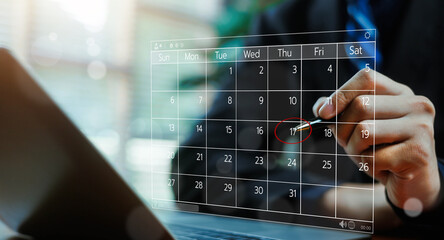 Business professional marking an important date on a digital calendar interface, representing planning, scheduling, deadline management, productivity, and modern corporate time management concepts.