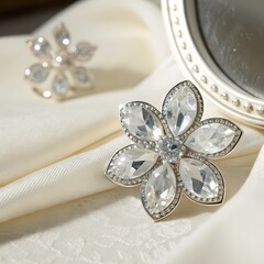 Crystal flower brooch with teardrop gemstones on ivory fabric near vintage mirror, perfect for bridal accessories, fashion catalogs, luxury product displays, or elegant gift promotions