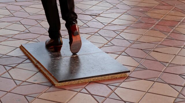 Flamenco shoes of a dancer performing footwork known as zapateado on an improvised tablao in Plaza de Espana, Seville, Andalusia, Spain