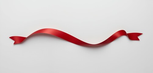 Graceful crimson satin ribbon undulating over pristine white backdrop