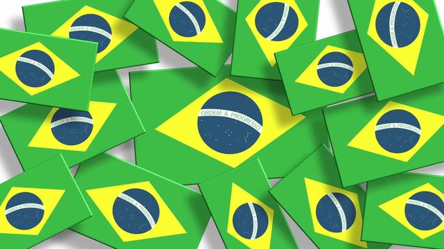 Pile of Brazil flags scattered randomly on a green surface