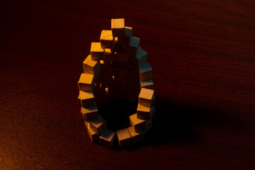 Geometric Ring Of Small Cubes Forming A Hollow Circular Structure On Dark Wooden Table