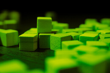Green Wooden Cubes Scattered On Dark Surface For Abstract Modularity And Colorful Texture Artistry