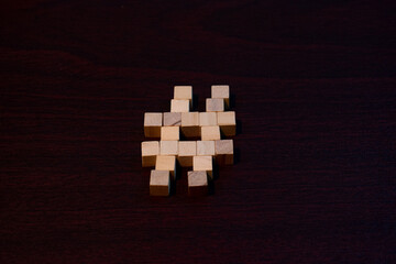 Hash Symbol made with Wooden Cubes On Dark Wood Surface