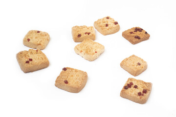 Assorted Square Cookies with Cranberry Bits Scattered on White Background