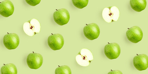 Green apple pattern on light green background. Repeat composition with fresh whole and sliced apples