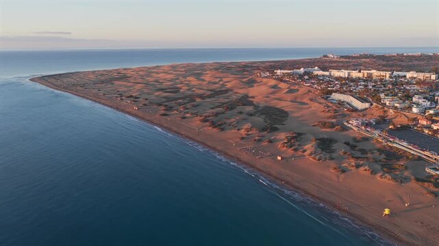 Cinematic 4K Aerial of the Maspalomas Special Natural Reserve Dunes at Sunrise, showcasing the World Biosphere Reserve and Volcanic Coastline, Gran Canaria, Spain