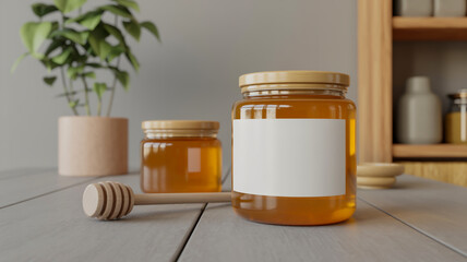 Two amber honey jars with wooden lids and a honey dipper on a wooden surface with a potted plant in the background