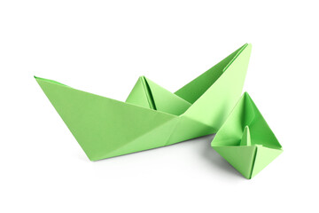 Green paper boats on white background