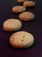 Fresh Sugar Cookies Displayed on Dark Wood Surface, Cozy Homemade Treats Ready to Enjoy