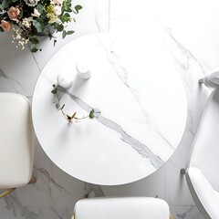Round marble table viewed from above, with two white chairs and a floral arrangement on matching tiled floor