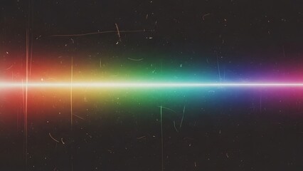 A vibrant rainbow light beam shines brightly in a dark space