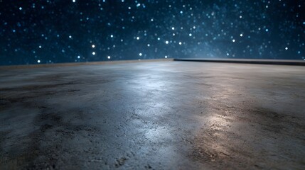 A textured concrete surface reflects the light of a vast starry night sky creating a dramatic and atmospheric vista