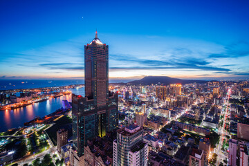 Obraz premium Aerial view of Kaohsiung 85 Sky Tower and Kaohsiung Harbor at sunset, Taiwan cityscape.