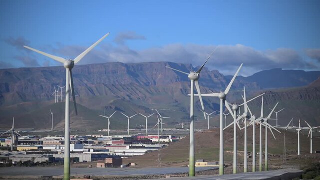 Sustainability in Motion: 4K Aerial of Passenger Aircraft Landing over the Arinaga Offshore Wind Farm and Renewable Energy Infrastructure, Gran Canaria, Spain