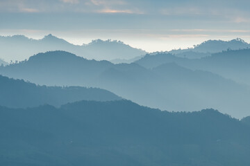 Soft Blue Layered Mountains in Morning Mist