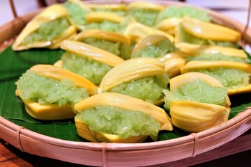 Sweet sticky rice with jackfruit served in a woven basket on banana leaves