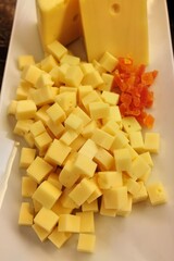 Delicious cubed cheese and dried fruit assortment on a white platter
