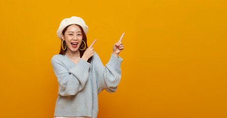 Advertising banner promotion concept with Asian woman pointing at empty copy space to highlight marketing message call to action creative content placement for digital campaigns.