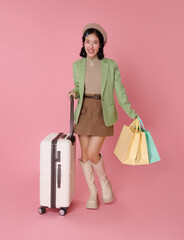 Travel shopping lifestyle concept with Asian woman holding suitcase and shopping bags while standing to represent tourism retail experience vacation spending modern consumer journey.