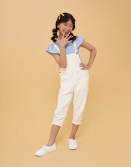 Surprised Asian girl with playful have fun isolated on pastel background child studio portrait. childlike emotion and creative expression