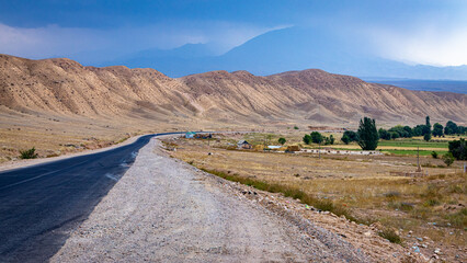 Gorgeuos winding mountain road to a desolate Son Kol lake Kyrgyzstan
