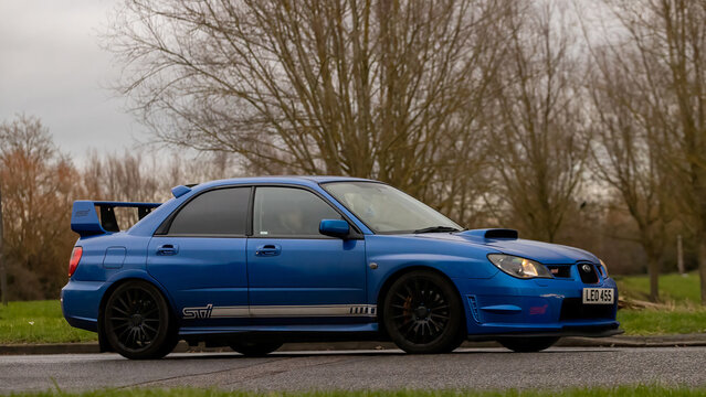 Milton Keynes,Bucks,UK - Jan 1st 2026: 2007 blue Subaru Impreza classic car driving on a British road