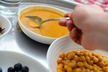 Person eating organic lentil soup and chickpeas for wellness, natural healthy meal with herbal ingredients and copy space, mindfulness and balance nutrition background for eco lifestyle.