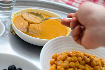 Person eating organic lentil soup and chickpeas for wellness, natural healthy meal with herbal ingredients and copy space, mindfulness and balance nutrition background for eco lifestyle.