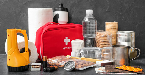 Necessities for emergency bag on dark table