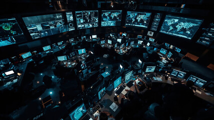High-tech command center with multiple monitors displaying global data and maps in a dark, futuristic environment