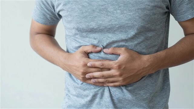 Man suffering from intolerance or food poisoning, stomach ache, abdominal pain, colon problems, gastritis, diarrhea or inflammation. Patient's hand on the belly or abdomen.	