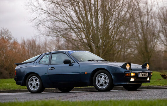 Milton Keynes,Bucks,UK - Jan 1st 2026:  1988 Porsche 944 classic car with pop-up headlights driving on a British road