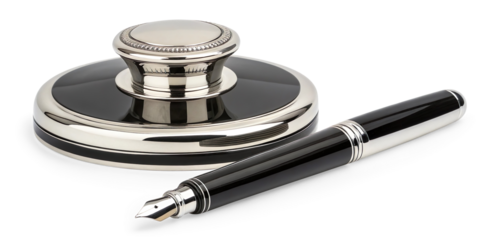 A polished, luxury writing set featuring an ornate silver inkwell with a black band detail, accompanied by a matching black and silver fountain pen resting beside it on a transparent background