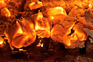 Homemade warm orange campfire with pieces of firewood. Burning firewood in the stove, coal, hot coals,