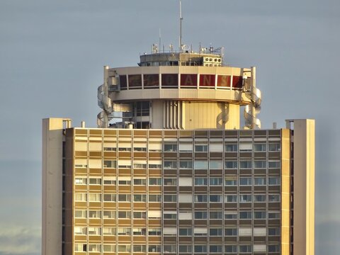 Europe Tower high-rise in Mulhouse, Alsace, France at golden hour, modernist architecture with rooftop panorama level, urban skyline and autumn hills