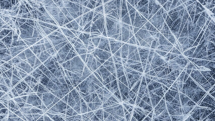 Close-up of a textured surface with numerous intersecting white lines creating an abstract, icy pattern on a dark background.