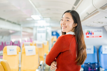  A young Asian woman, a passenger on the plane, embarks on a study abroad journey, representing cultural exchange and academic experiences in international education.