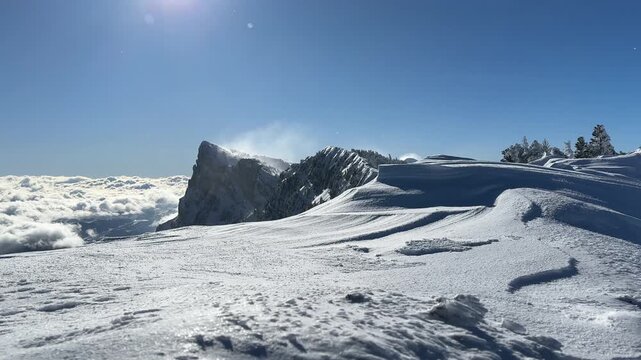 Pic Saint Michel covered by fresh snow ; winter landscape in Vercors mountain range ; Sunny day in mountains above the clouds