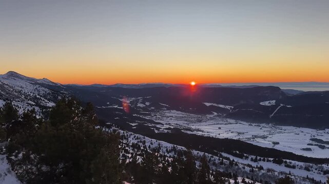 Sunset on the Vercors mountain range covered by snow ; panoramic view on the Vercors in winter from the top of the mountain